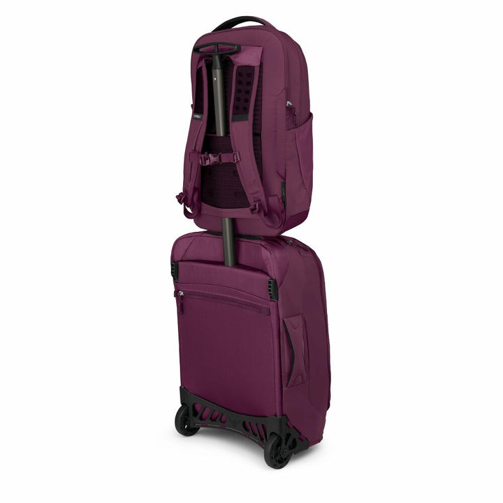Purple suitcase and backpack set on a white background