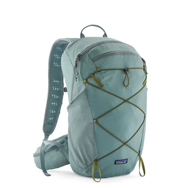 A Patagonia backpack in a muted sage green color, featuring olive green compression straps and a matching green hip belt, shown on a clean white background.