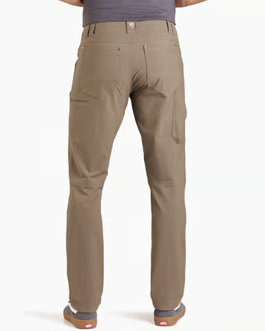 A person shown from the back wearing khaki cargo pants, a gray top, and brown shoes against a plain light gray studio background.