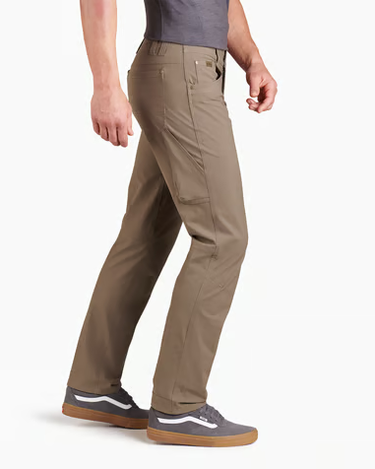A person wearing khaki cargo-style pants, a gray sleeveless top, and gray sneakers with white side stripes, shown from the waist down against a clean white studio background.