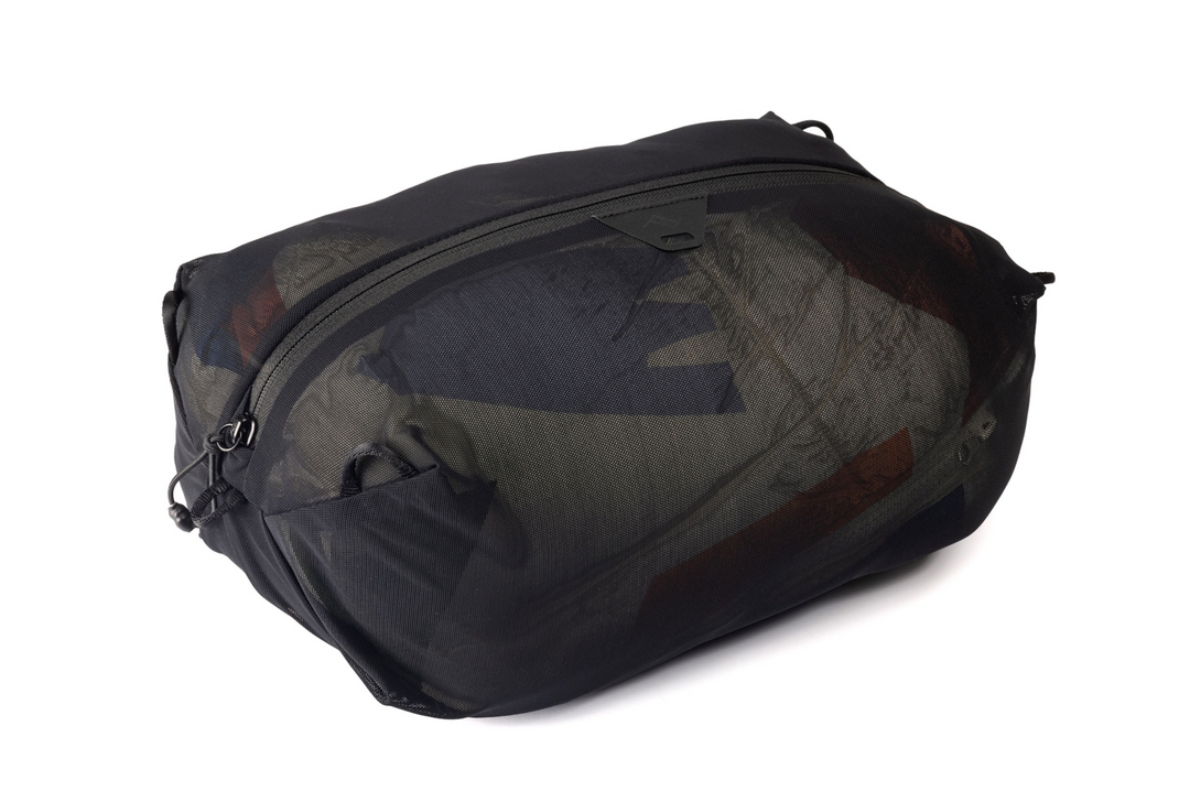 A black mesh duffel bag with a camouflage-patterned interior lining, shown at an angle on a white background.