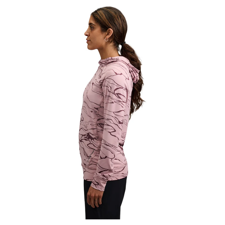 Woman wearing a pink camouflage hoodie on a white background
