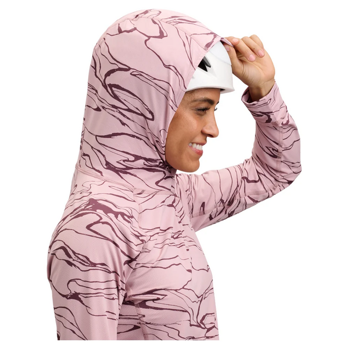 Woman wearing a pink camouflage hoodie on a white background