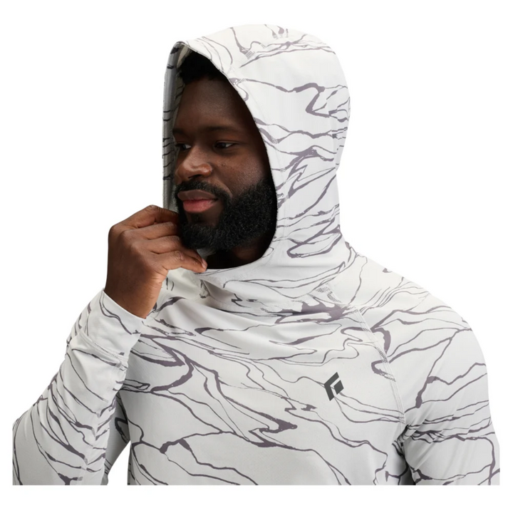 Person wearing a white and gray patterned hoodie on a white background