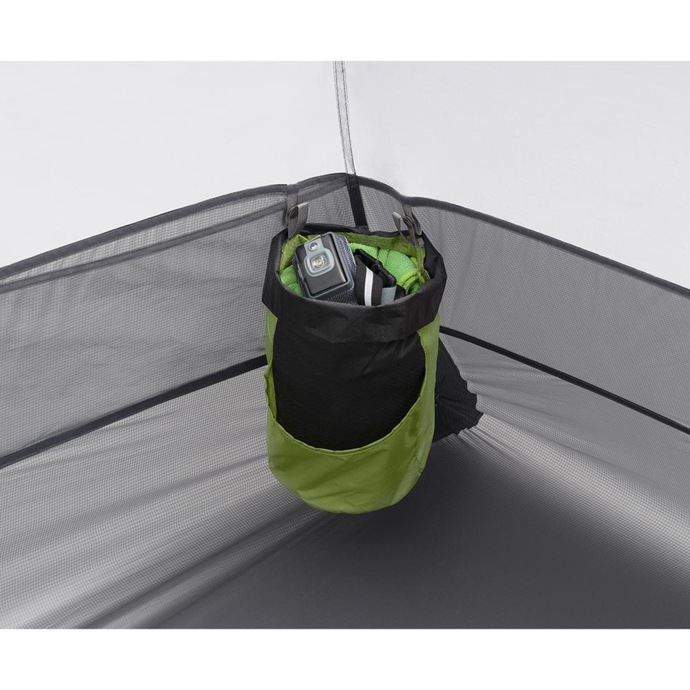 Green and black hanging storage bag in the corner of a tent