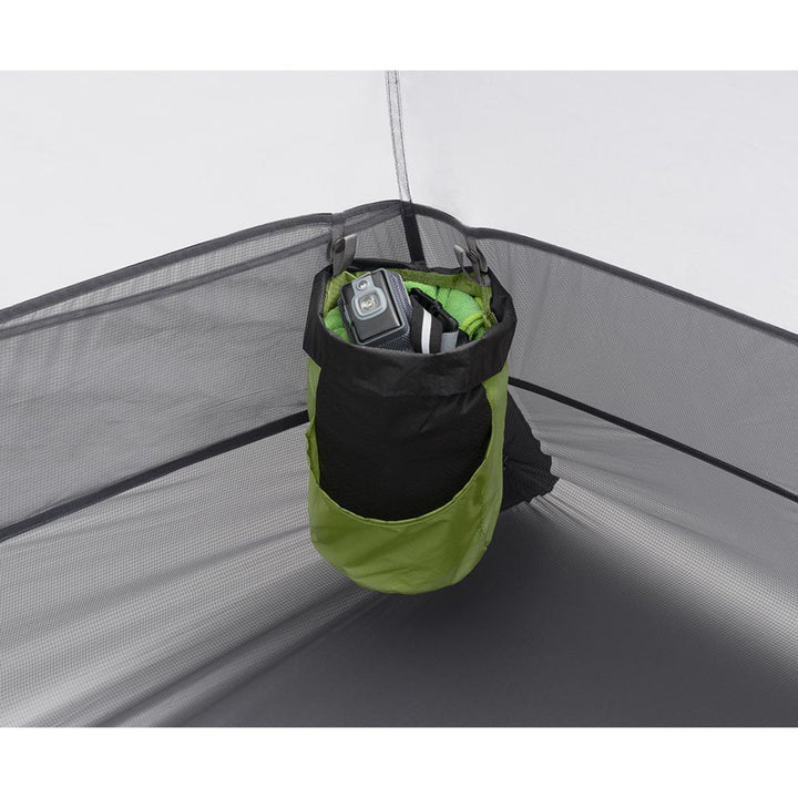 Green and black hanging storage bag in the corner of a tent