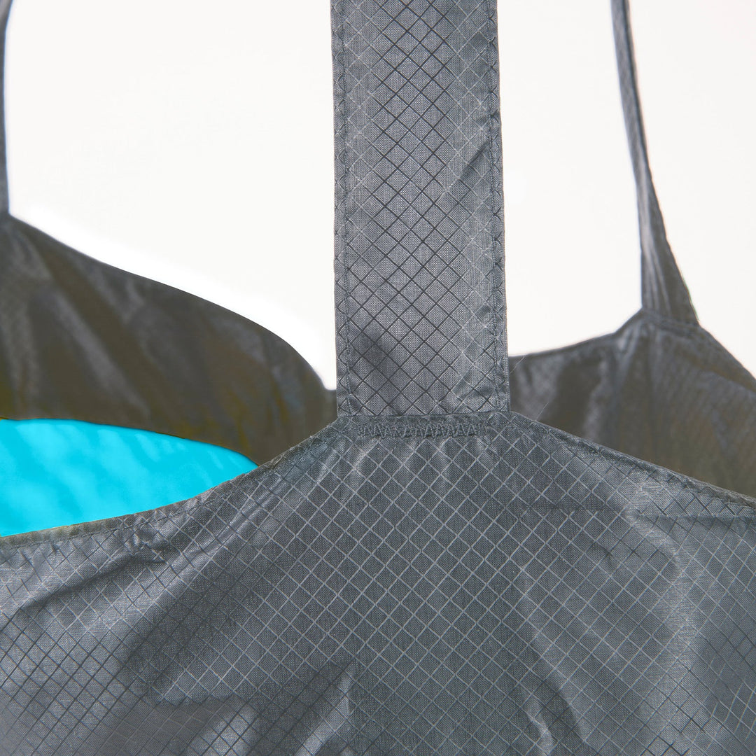 Close-up of a ultra-sil grey bag with a blue interior on a white background