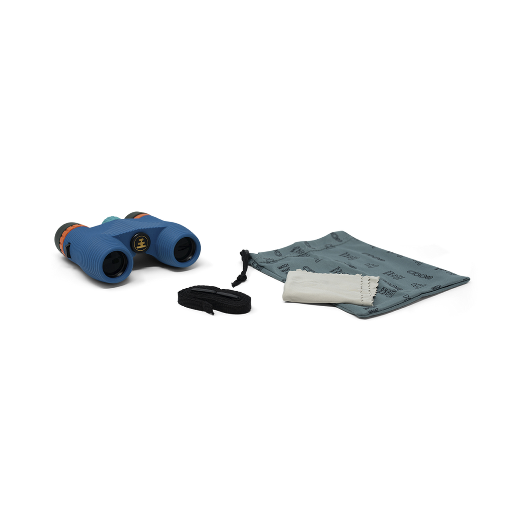 Blue binoculars with carrying strap, carry bag, and cleaning cloth on a white background