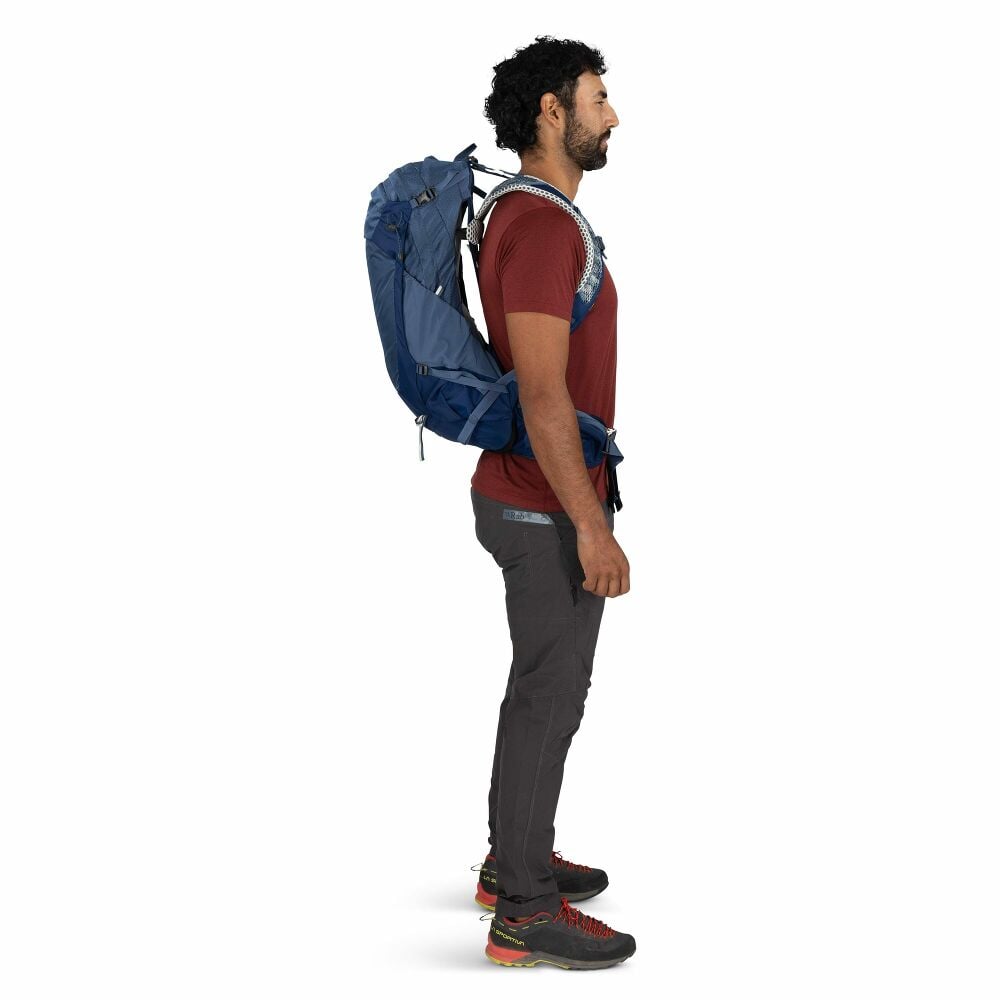 Man wearing a blue backpack on a white background