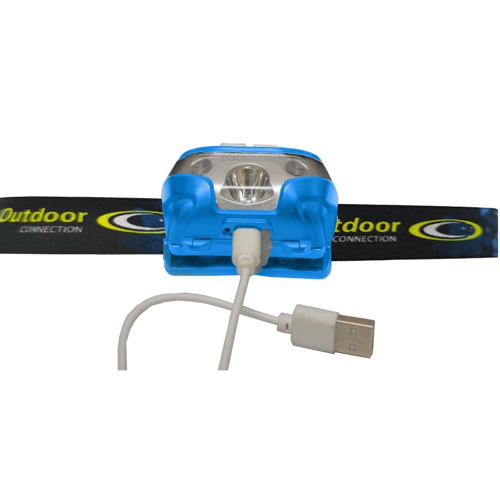 A blue and silver USB rechargeable headlamp clipped onto a black branded head strap, with a white USB charging cable shown in front on a white background.