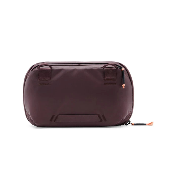Brown toiletry bag with black accents on a white background