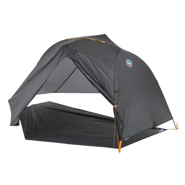 Grey hiking tent fly pitched on a grey footprint without an inner tent