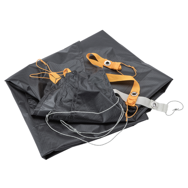 Folded grey hiking tent foot print with orange and grey webbing attachments