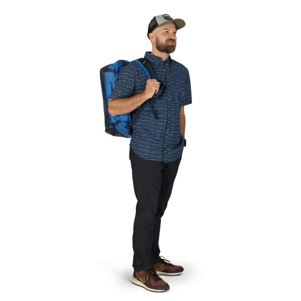 Man wearing a blue backpack on a white background