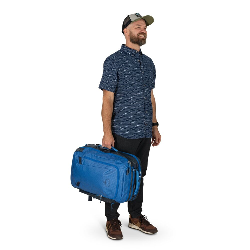 Man holding a blue suitcase on a white background
