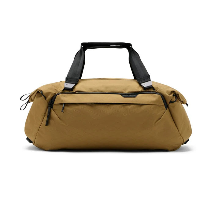 A tan nylon duffel bag with black handles and zipper pulls, shown from the front on a white background.