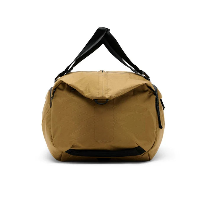 Brown duffel bag with black straps on a white background