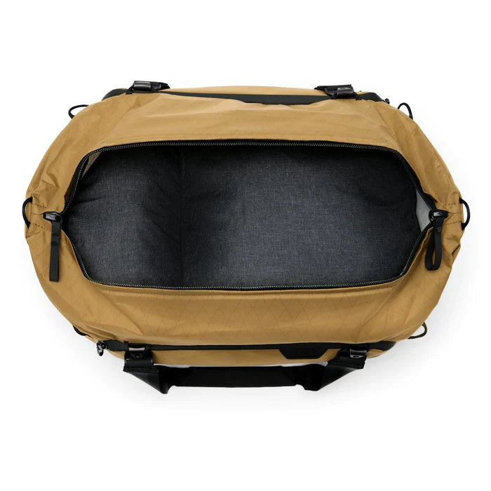 Tan backpack with black interior on a white background