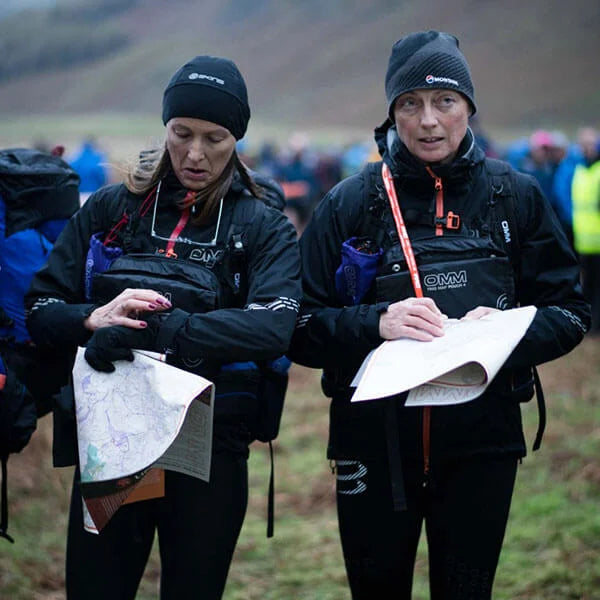 OMM Trio Map Pouch in Black, in use during a mountain race