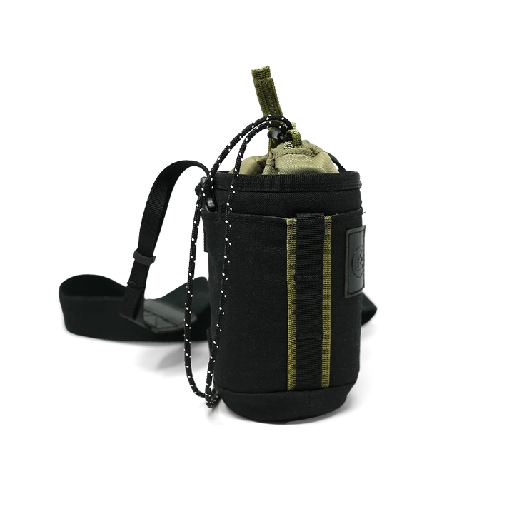 A black tactical bag with olive green accents, featuring a drawstring closure, a hanging chain, and a black strap, shown on a white background.