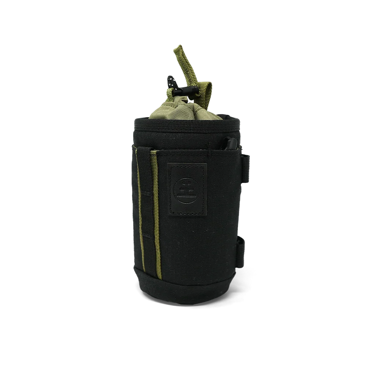 A black cylindrical pouch or sleeve with olive green accents, including a top loop and side piping, shown on a plain white background.