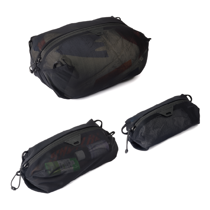 Three black mesh packing cubes in different sizes on a white background 