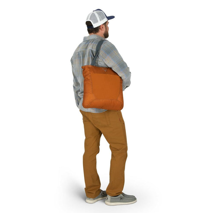 Man carrying an orange bag on a white background