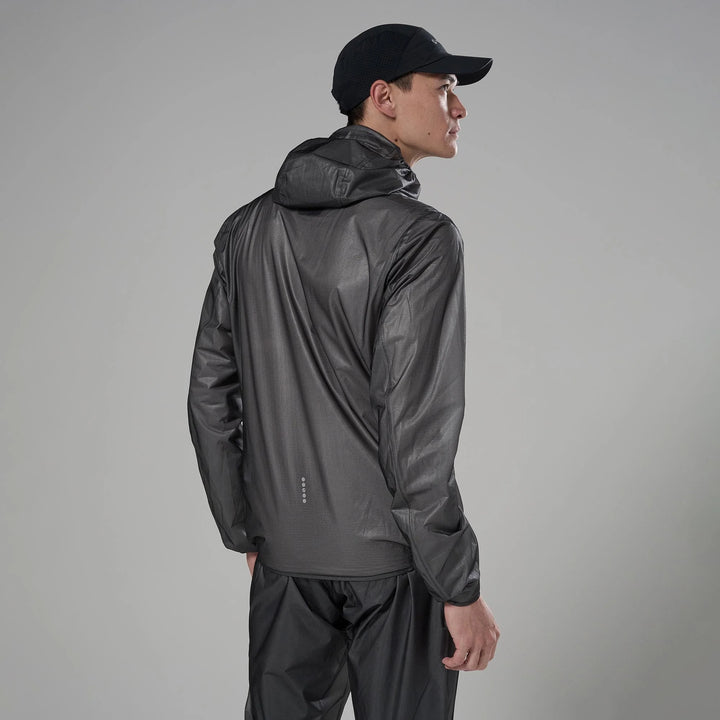 Person wearing a dark gray raincoat and pants on a gray background