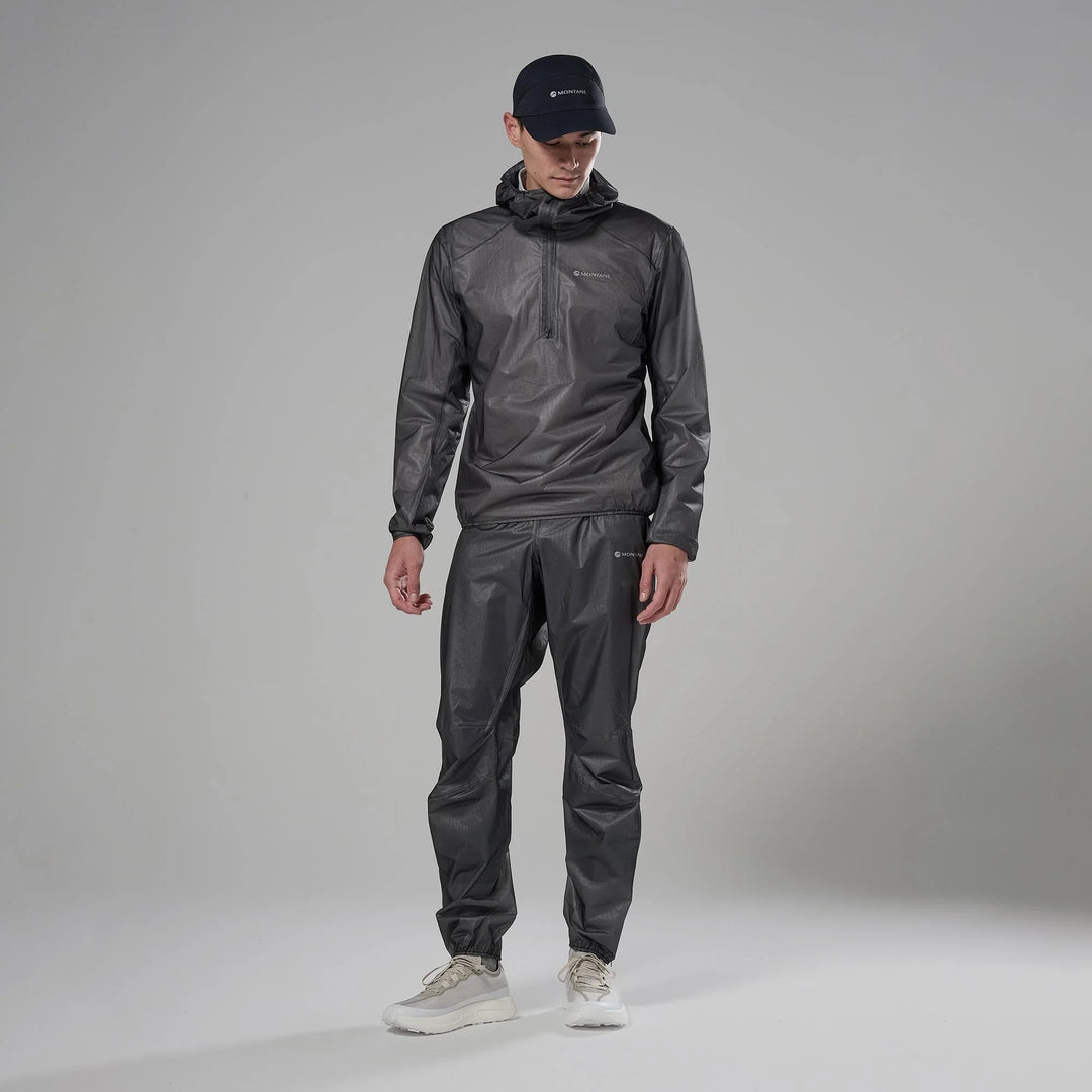 Person wearing a gray rain suit and cap on a gray background