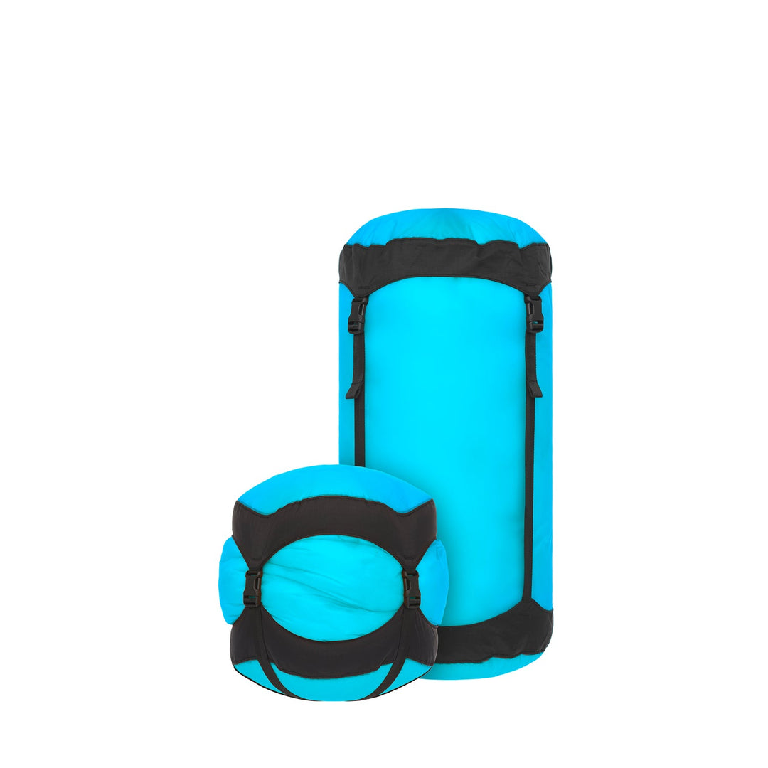 Two blue and black compression sacks on a white background