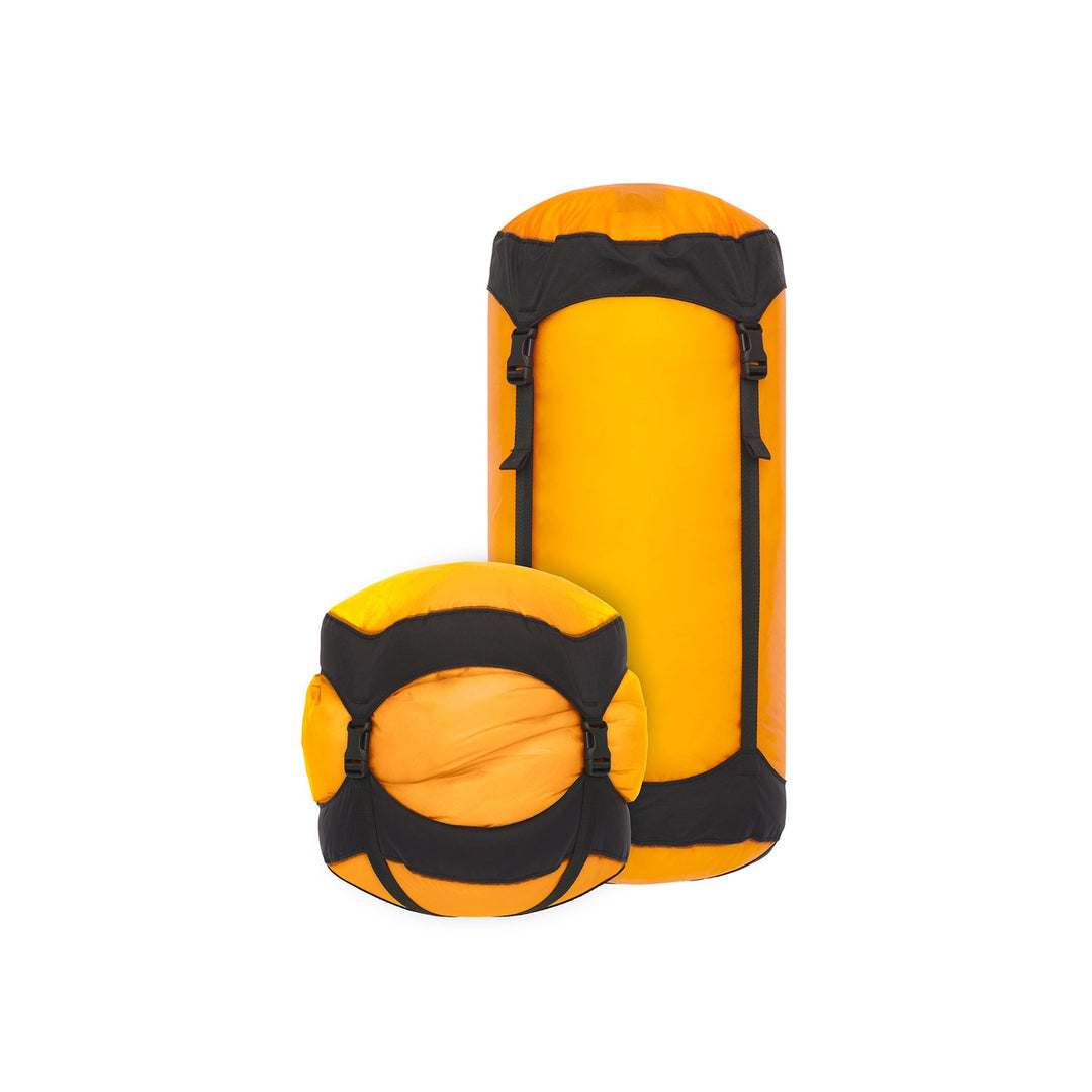 Two yellow and black compression sacks on a white background