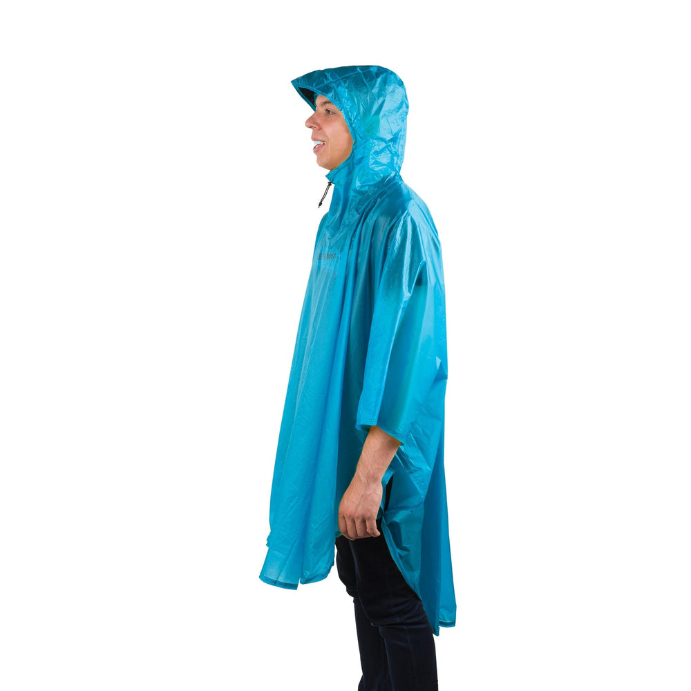 Person wearing a blue rain poncho on a white background