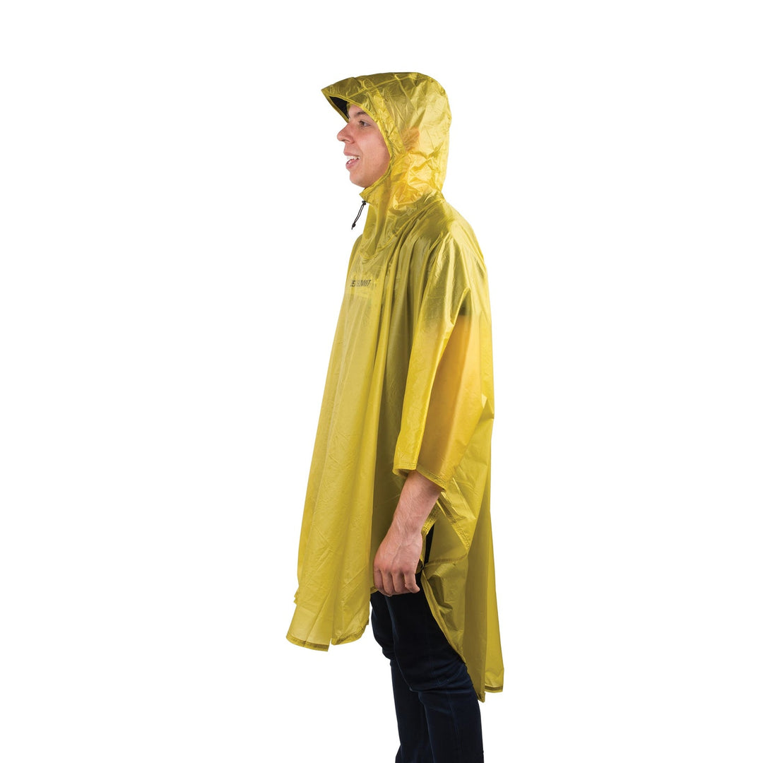 Person wearing a yellow rain poncho on a white background