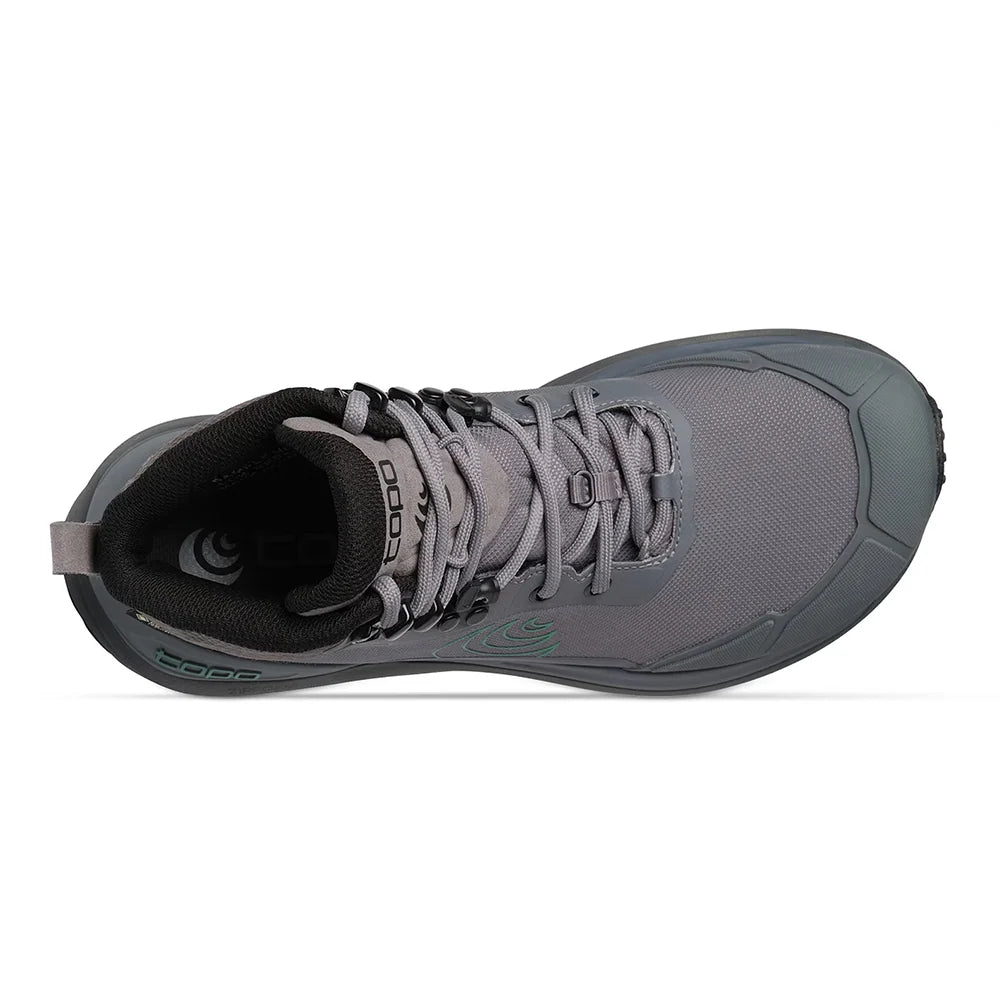A gray mid-cut hiking boot with a dark gray sole, black laces, and a green circular logo on the side, shown against a plain white background.