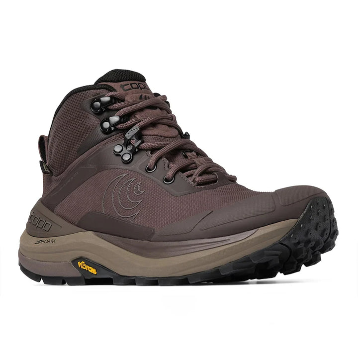 A single mid-cut hiking boot in dark brown and taupe with black laces and a rugged black outsole, shown from a side profile on a white background. The brand Topo is visible on the side and tongue.