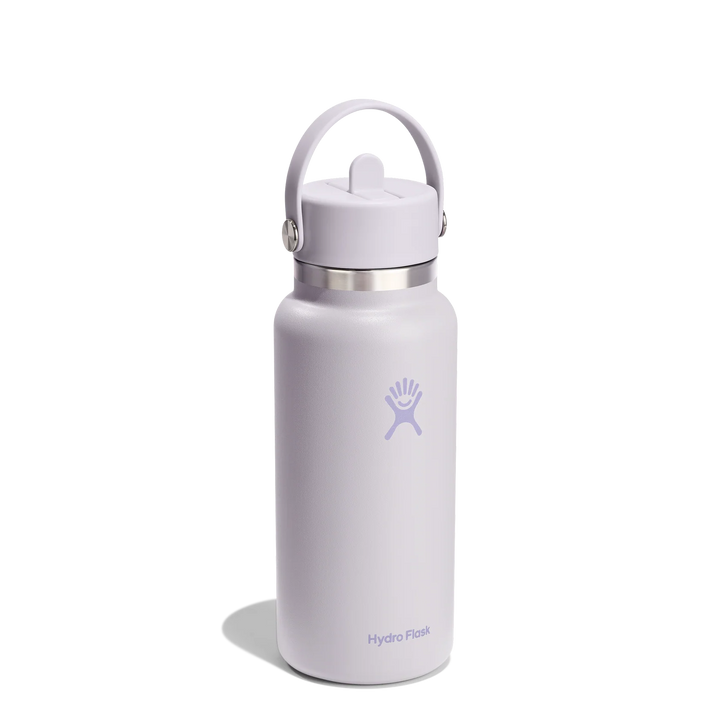 A Hydro Flask insulated water bottle in a light lavender purple color, featuring a matching purple carry loop lid and a silver stainless steel neck collar, set against a plain white background.