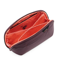 Purple toiletry bag with orange interior on a white background