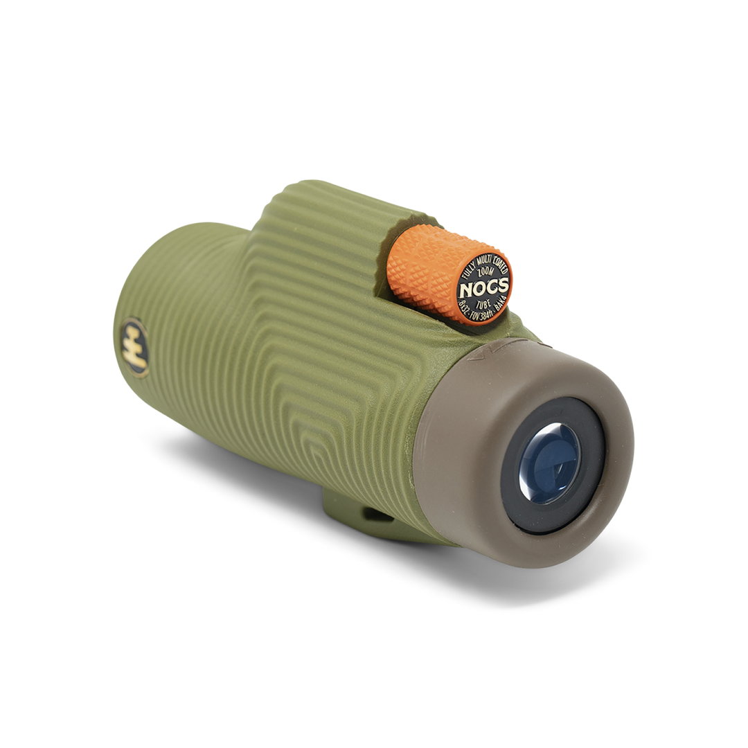 Green and beige monocular with a Nocs logo on a white background