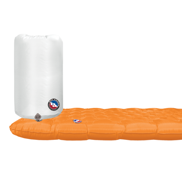 Orange inflatable sleeping mat with a white pump sack