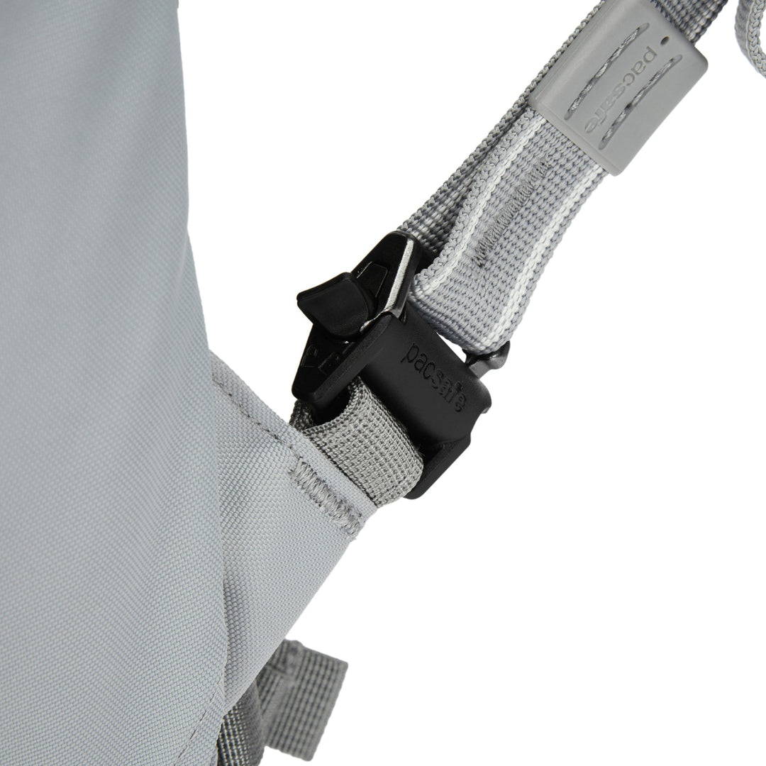 Close up of a releasable attachment point at the bottom of a  backpack shoulder strap