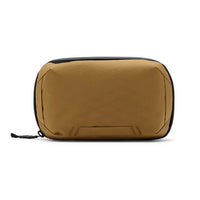 A tan waterproof pouch with black trim and a black zipper pull, shown from the front on a white background.
