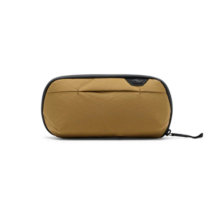 Quilted brown toiletry bag with black zipper on a white background