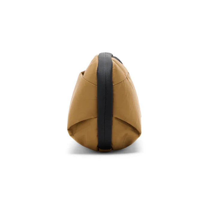 Brown bag with a black strap on a white background