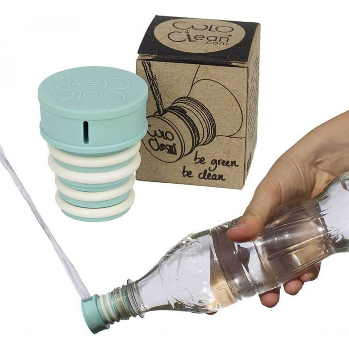 Pale blue portable bidet screwed onto a plastic bottle and squirting water, packaging in background