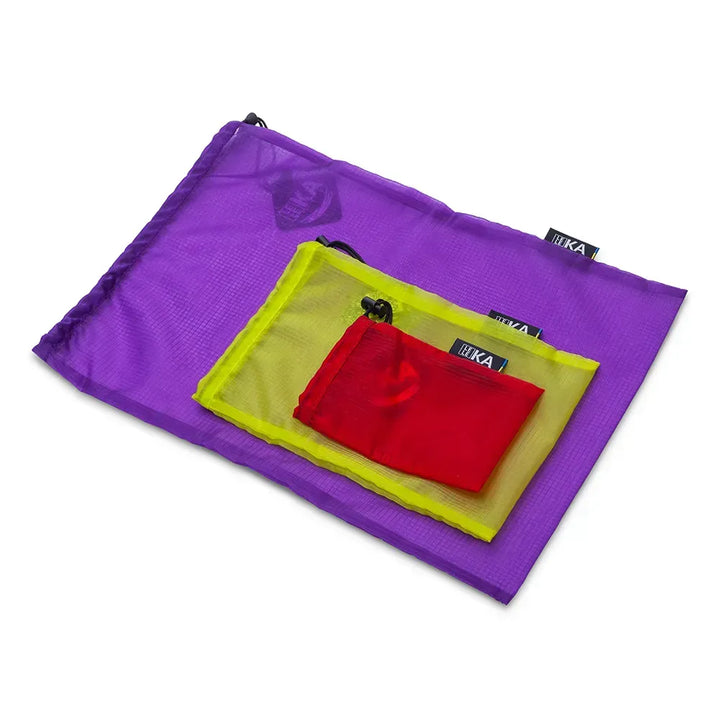 Three nested mesh pouches in purple, yellow, and red, with black tags showing the brand &