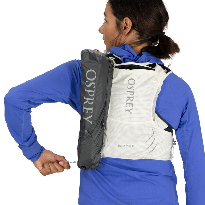 Person wearing a white Osprey hydration vest and grey quiver on a white background