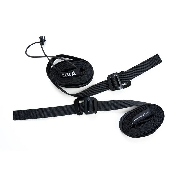 Two rolled up black hammock straps with Leleka branding on a white background. 