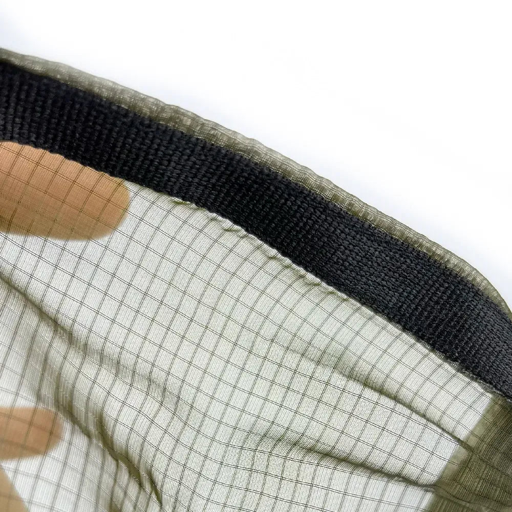 Close up of dark olive mesh hammock material.
