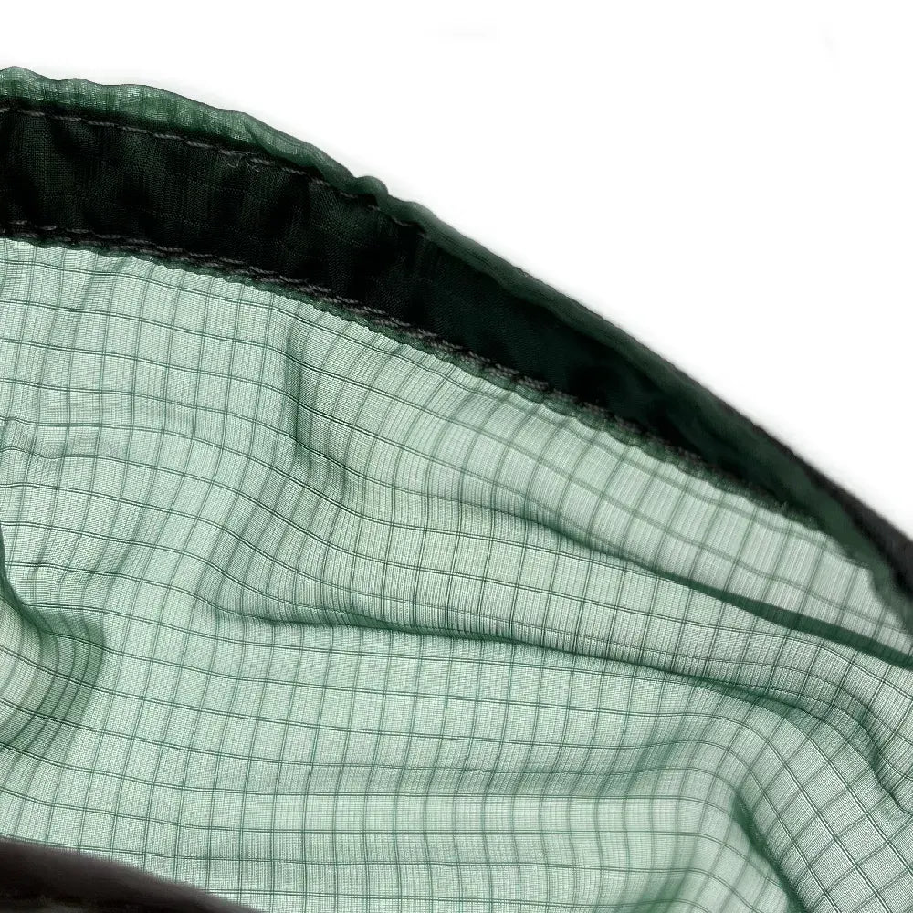 Close up of dark green mesh hammock material.