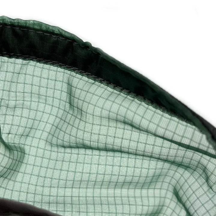 Close up of dark green mesh hammock material.